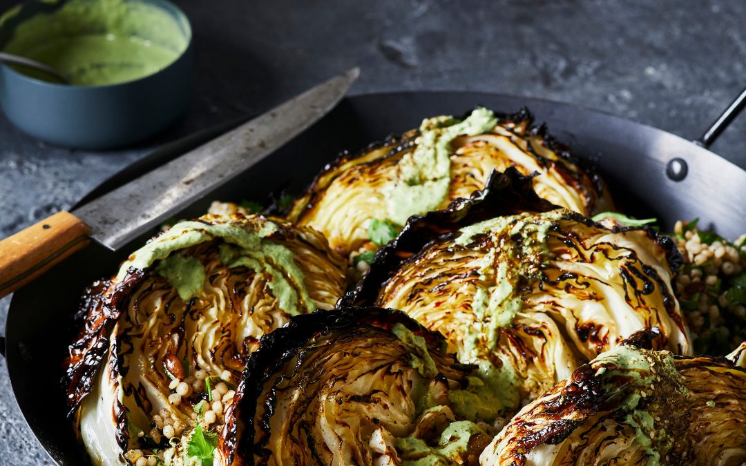Roasted cabbage with green goddess tahini and spiced pearl couscous